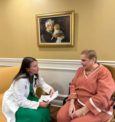 Healthcare professional consulting with a resident