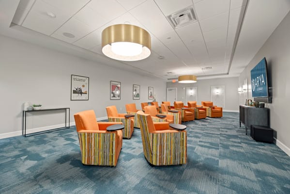 Interior lounge area with bright orange chairs