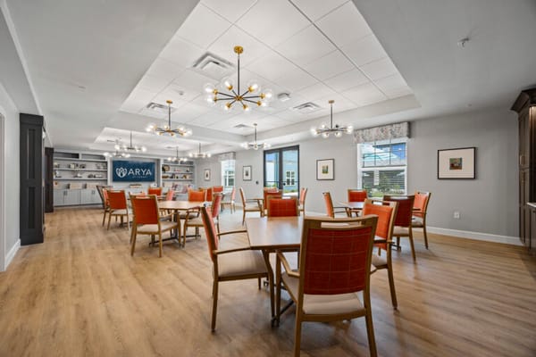 Bright and spacious common area with dining tables