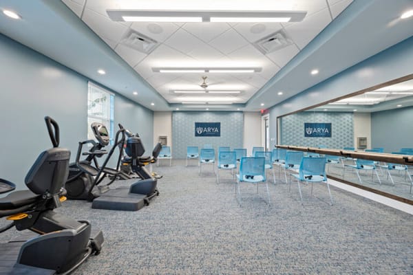 Interior fitness area with exercise equipment and chairs