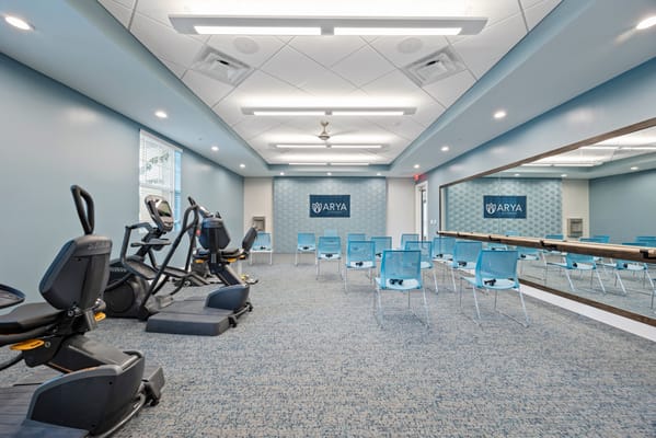 Interior fitness area with exercise equipment and chairs
