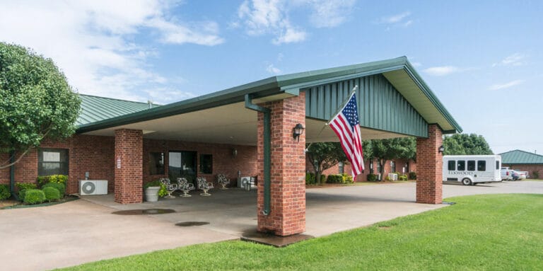 Entrance of a senior facility with an American flag