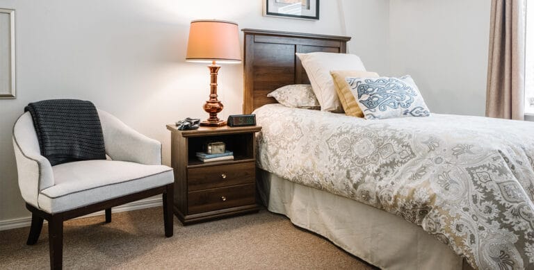 Cozy bedroom with decorative bedding and lamp
