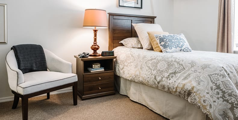 Cozy bedroom with decorative bedding and lamp