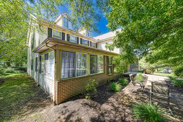 Exterior view of a senior living facility surrounded by greenery