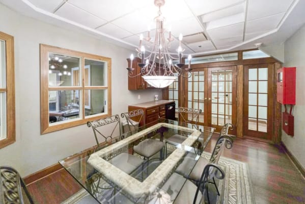 Dining area with elegant furnishings and chandelier