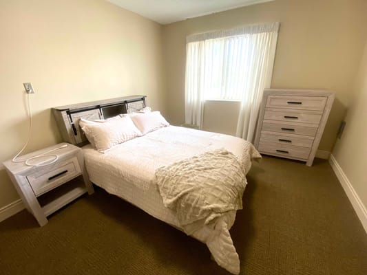 Cozy private resident room with bed and furniture