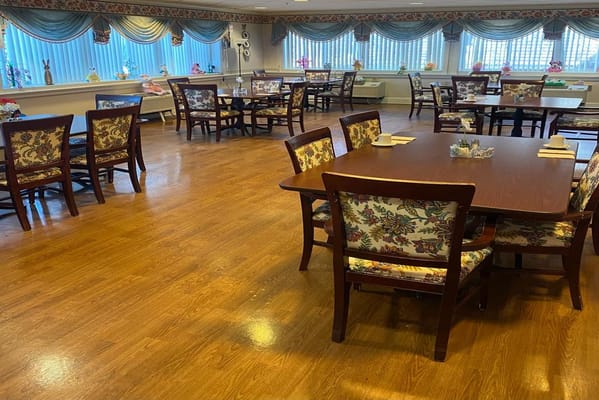 Dining room with wooden tables and floral chairs