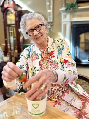 Resident enjoying strawberries in a common area