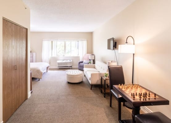 Well-lit interior of a resident room with furnishings