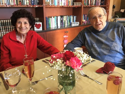 Two residents enjoying a decorated dining area