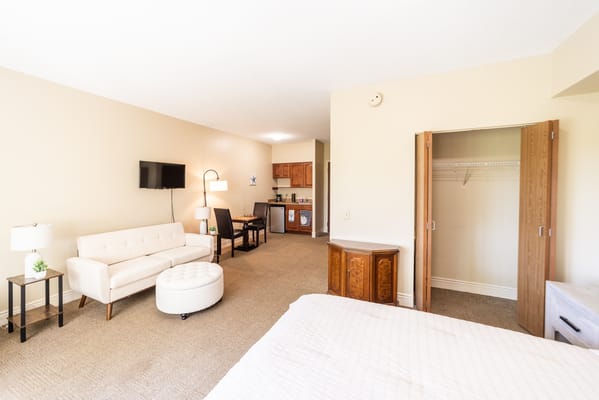 A spacious interior room with a living area and kitchenette