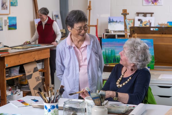 Residents engaging in an art activity in a common area