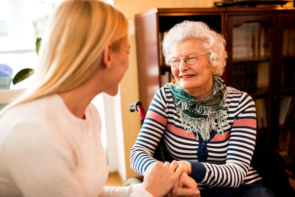 A caregiver conversing with a joyful resident