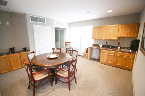 Bright interior of a private resident room with dining area