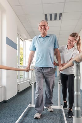 Therapist assisting resident during rehabilitation exercise