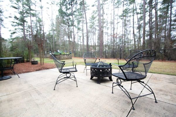 Outdoor seating area with chairs and fire pit