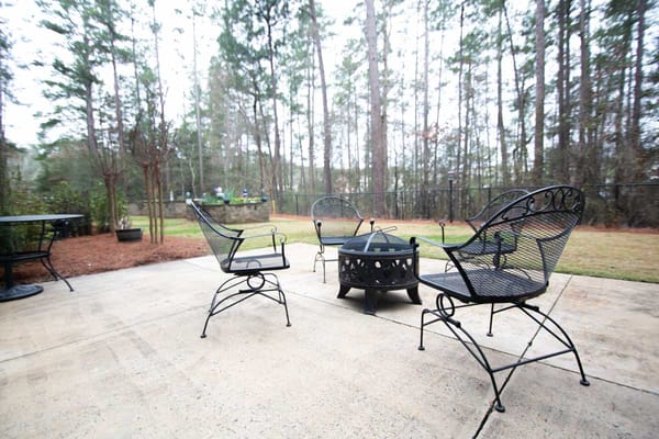 Outdoor seating area with chairs and fire pit
