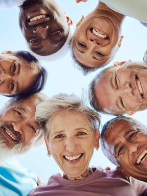 Residents and staff smiling together in a group