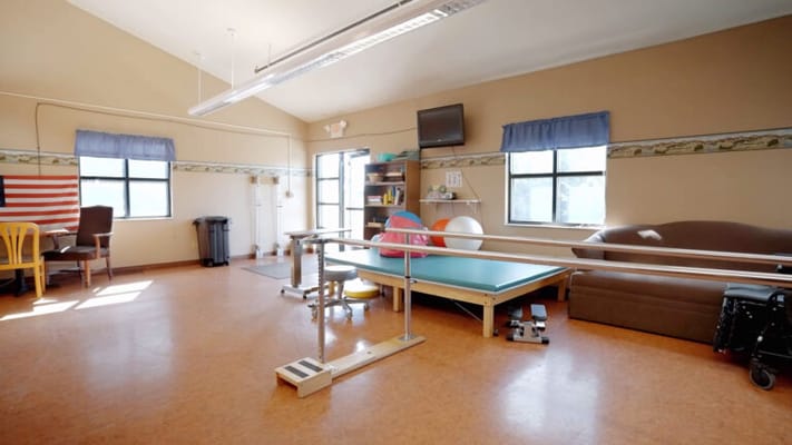 Interior view of a physical therapy room with equipment