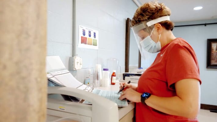 Staff member assisting with paperwork in an office