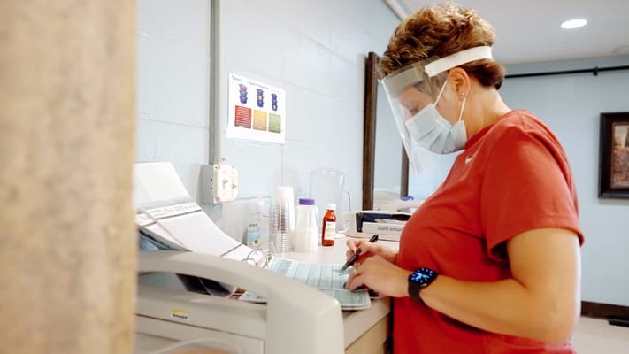 Staff member assisting with paperwork in an office