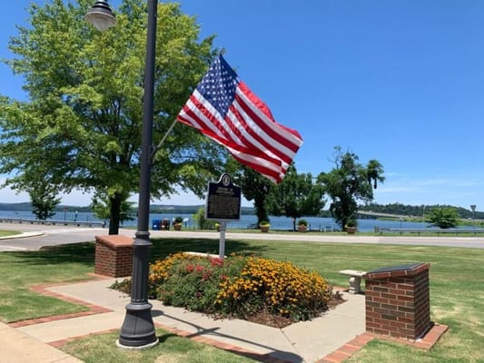 View of a park area with a flag and flowers
