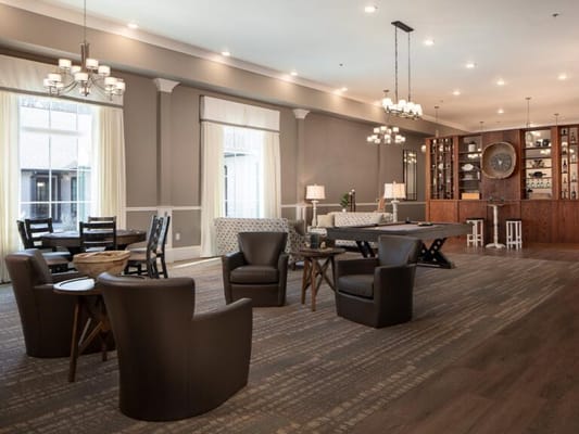 Bright interior common area with seating and a bar