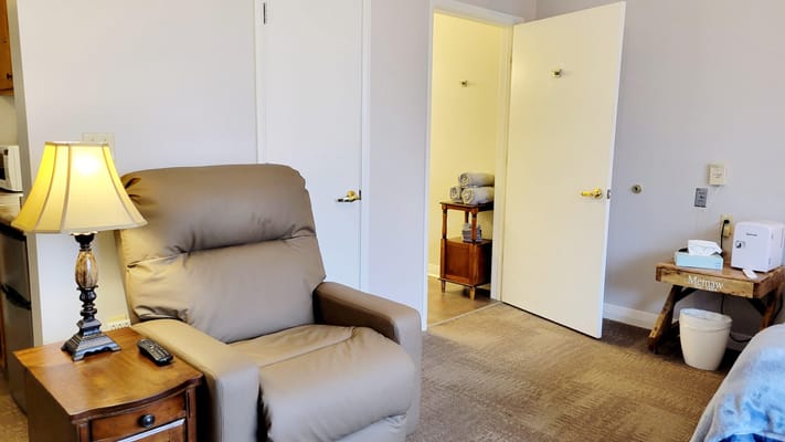 Cozy private resident room with a comfortable chair