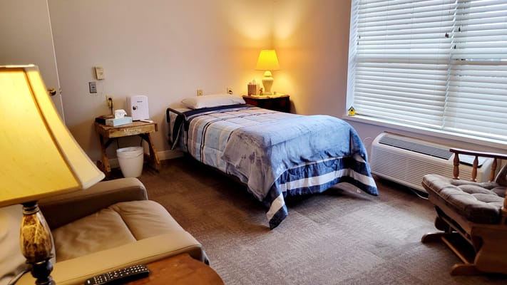 Cozy resident room with bed and seating area