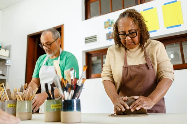 Residents participating in a pottery activity
