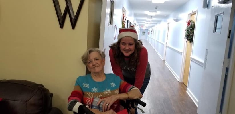 Residents smiling in a decorated hallway