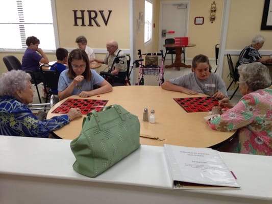 Residents participating in a bingo game in a common area
