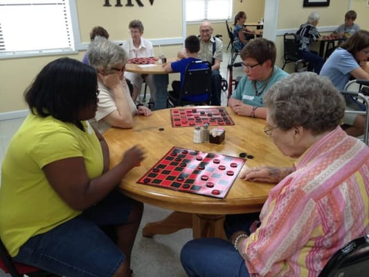 Residents engaged in a game of checkers