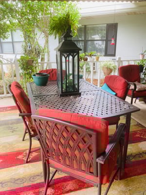 Cozy outdoor seating area with plants and lantern