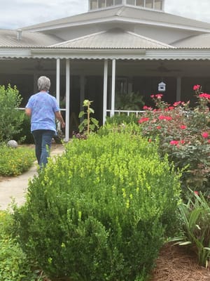 Resident walking through a beautifully landscaped garden