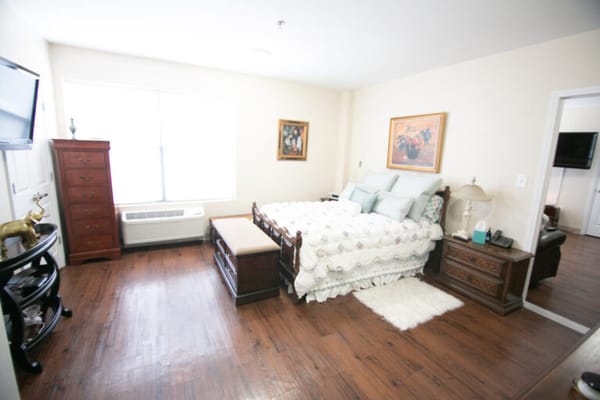 Cozy bedroom with wooden furniture and window light