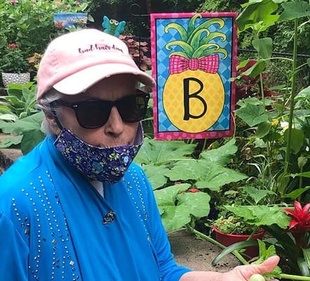 Resident in a garden wearing a mask