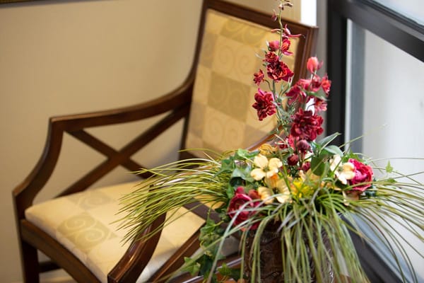 Decorative floral arrangement next to a chair