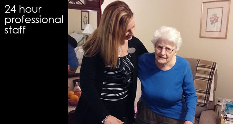 Staff assisting a resident in a cozy room