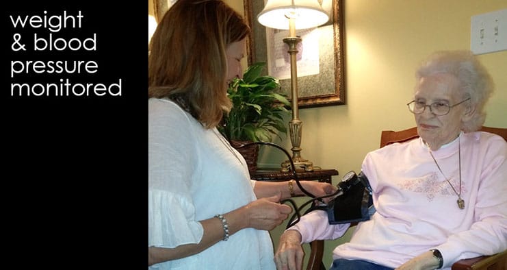 Nurse monitoring a resident's blood pressure in a cozy setting