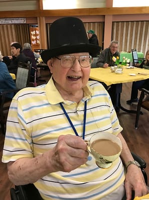 Resident enjoying a warm drink in a common area