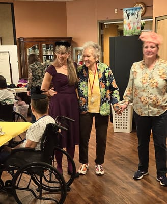 Residents participating in a lively activity with staff assistance