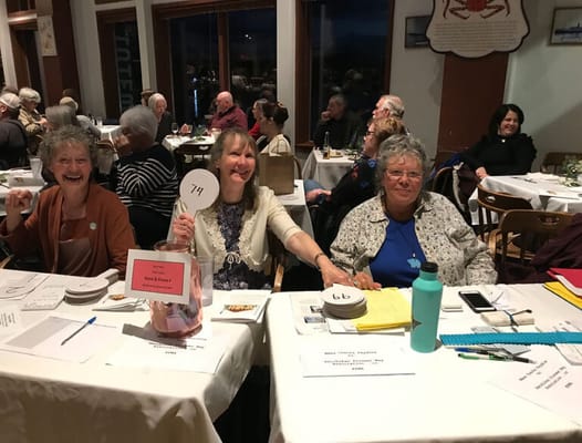 Residents enjoying an evening event, holding numbered signs