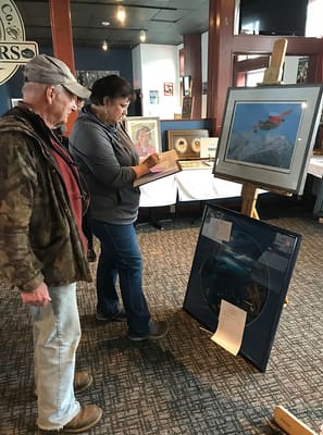 Residents engaging with artwork in a common area