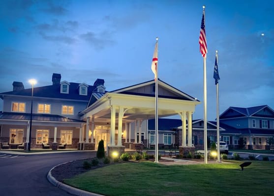 Exterior view of Grand South Senior Living at dusk