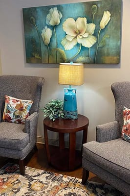 Cozy seating area with floral decor and lamp