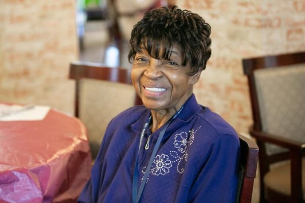 Smiling resident in a communal area.