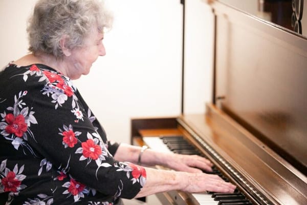 Senior woman playing piano in a facility
