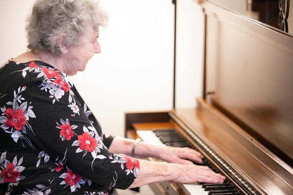 Senior woman playing piano in a facility